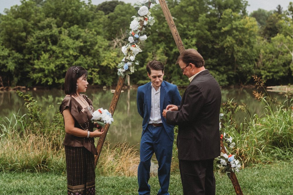 The Gifford Officiating wedding arch dressed with flowers at a lakeside ceremony