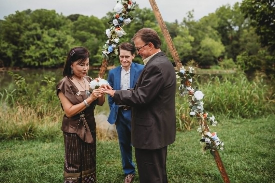 Lucy placing the ring on Andy's hand during their ceremony
