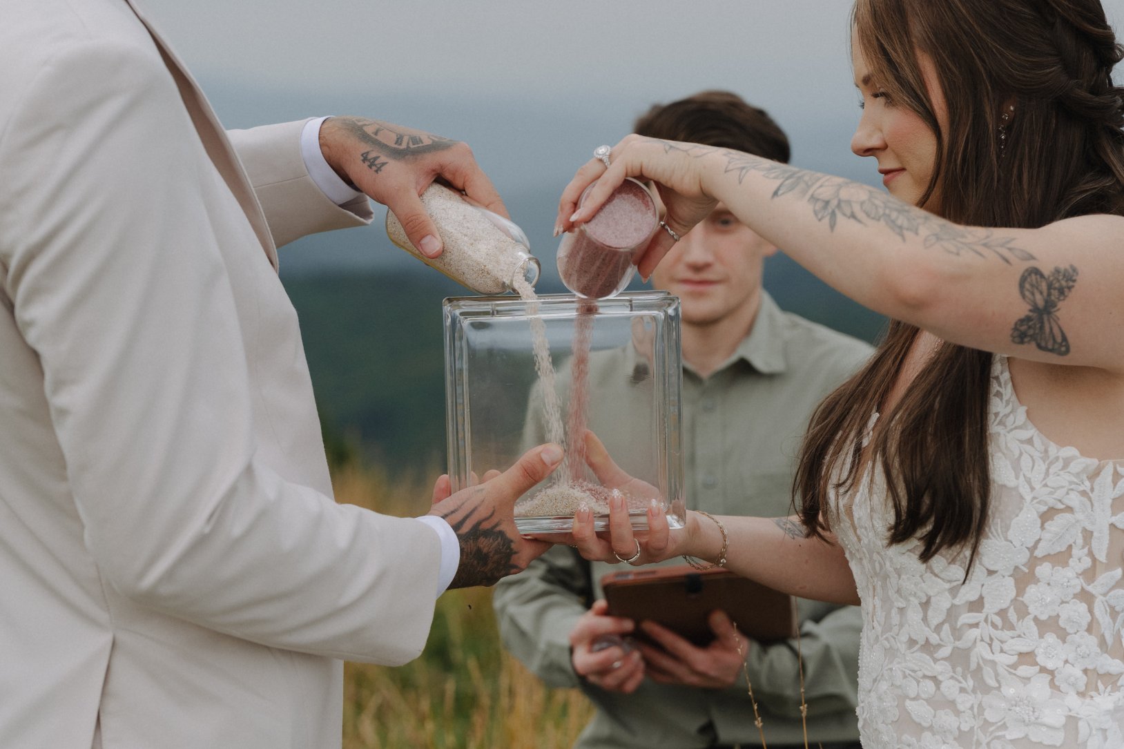 Ashley and Kenneth pouring unity sand during their mountain ceremony