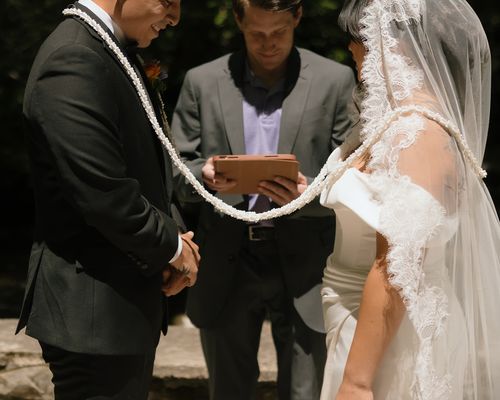 Close view of the white lasso resting around Raynita and Charlie's shoulders