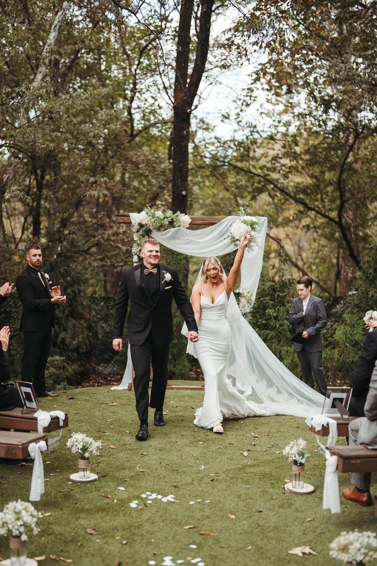 Cushi and Sam walking back down the aisle at The Post and Beam