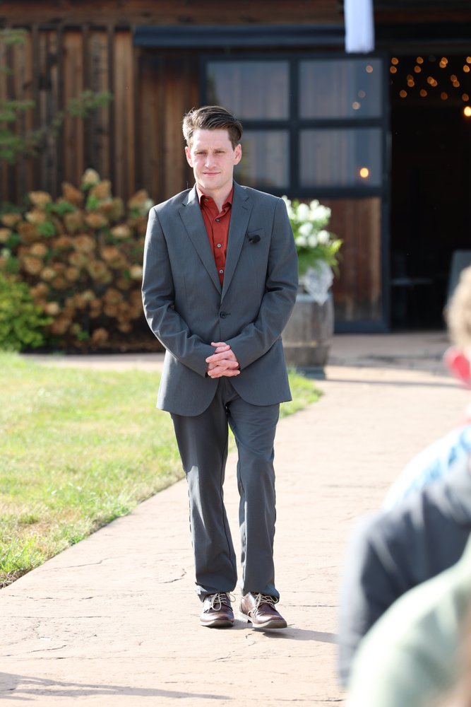 Nathan Gifford, wedding officiant, waiting at a barn venue before a ceremony