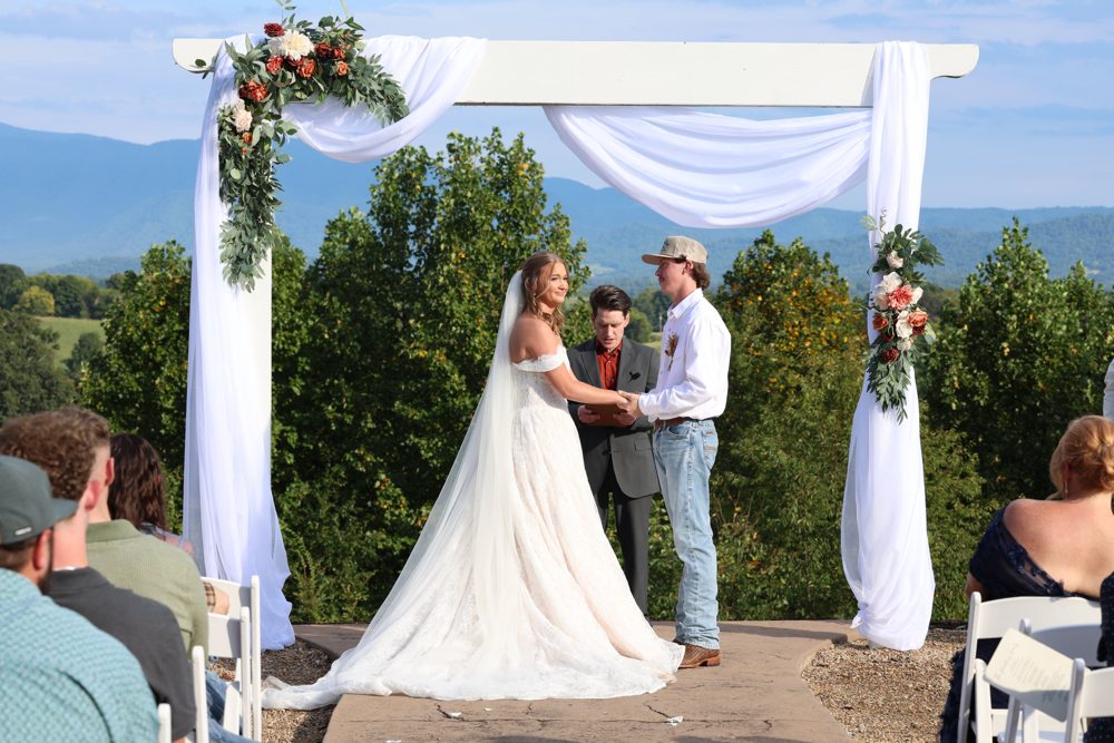 The mountain-view ceremony Nathan officiated for Amy Eggers' daughter, under a white draped arch